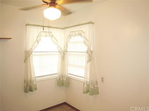 Corner Dining Area Gets a Nice Breeze from the Windows and the Ceiling Fan