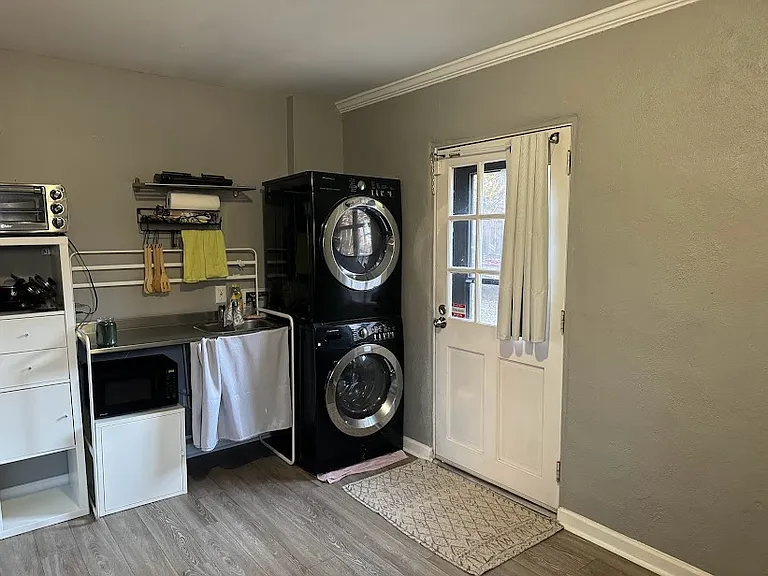 Kitchenette and WD. Private entrance leads to the fenced in backyard.