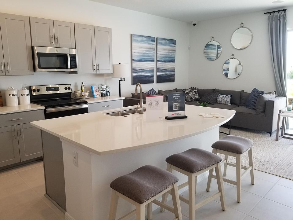 Open-concept kitchen living area of the model home of the same townhouse plan, Jasmine