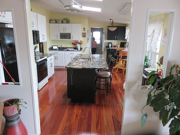 remodeled kitchen with Brazllian cherry hardwood floors and granite counter tops. Enter the kitchen through the large utility room