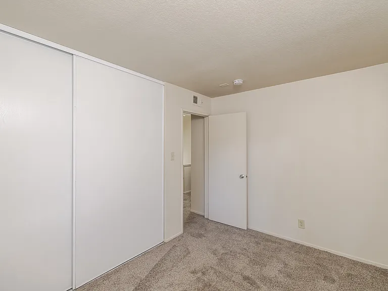 Spacious and quiet, Bedroom C features a large closet and neutral tones.