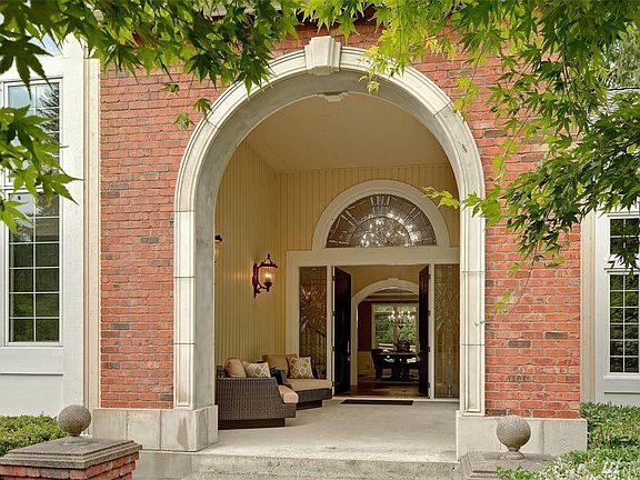 English Country architecture, circular drive, side turned 4 car garage and southwest backyard exposure.