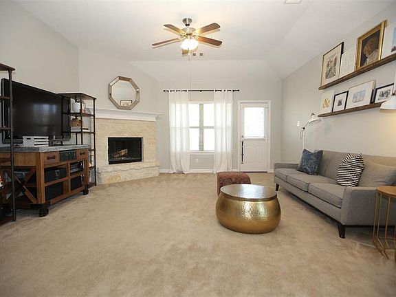Cozy a fireplace for chilly days, and a window looking out on to the fully fenced back yard.