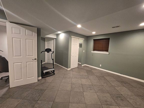 Large bedroom with entrance to bathroom in middle.