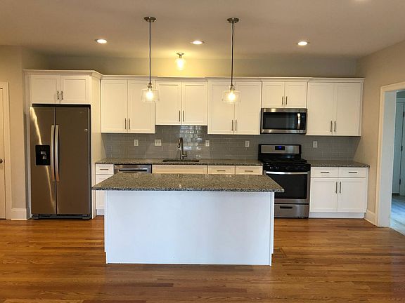 Kitchen includes stainless steel appliances, granite countertops, island and pantry closet. Ample cabinets for storage. Open concept floor plan on main level.