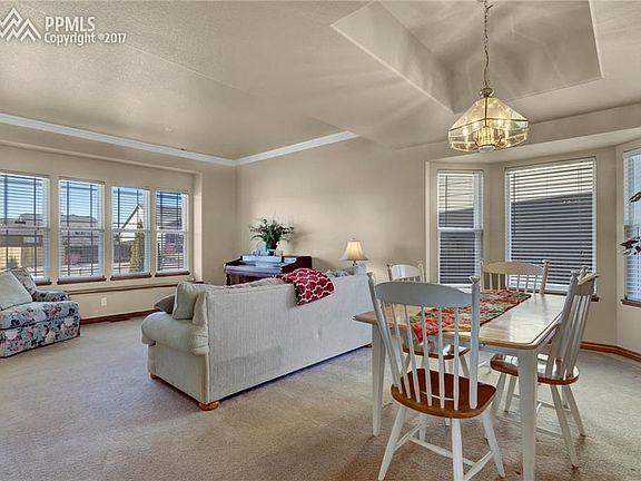 A large formal living room/dining room area with a bay window and tray ceiling!