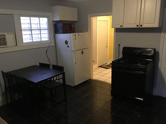 The full sized kitchen leads to a back hallway that accesses a small courtyard.