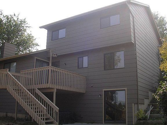 Rear of the home with walkouts to deck and patio.