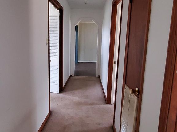 Hallway to bedrooms, bathroom, living room, and dining room