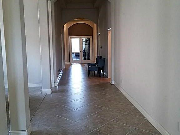 Amazing arched hallway leads you to the great room.