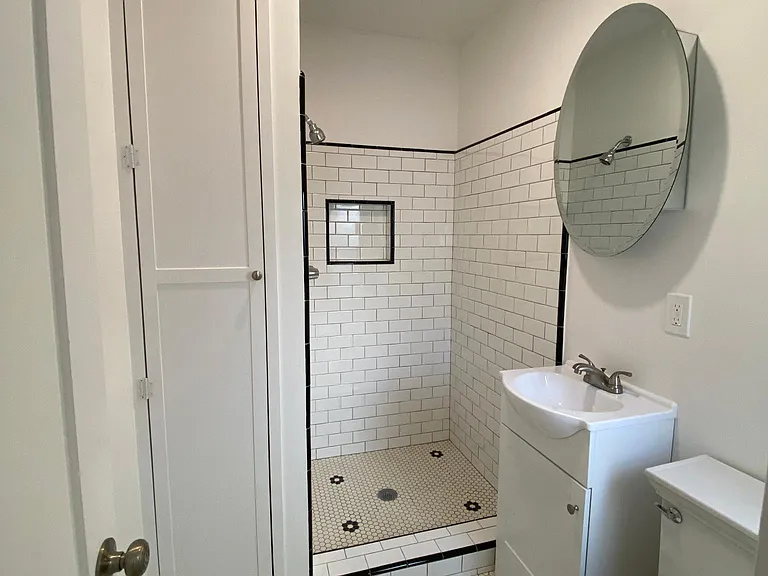 LUXURIOUS BATHROOM APPOINTED WITH LARGE LINEN, TOWEL AND SUNDRY CLOSET, VANITY AND KOHLER BRAND PLUMBING FIXTURES