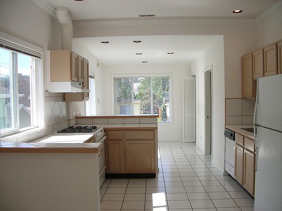 Open kitchen with seating or office space back by window