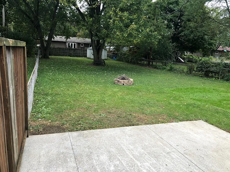 BIG BACKYARD! Fenced in. Perfect for dogs! Big concrete patio for outdoor furniture. Firepit will stay!