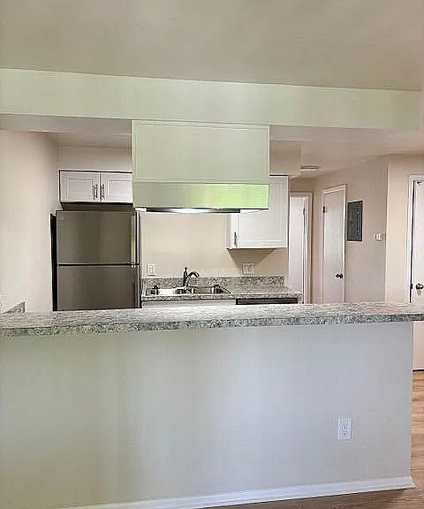 Modern kitchen with sleek stainless steel appliances, elegant countertop, and contemporary cabinetry.