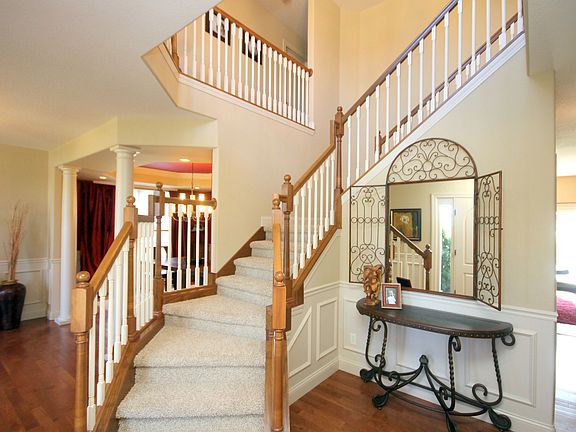 Exquisite 2-Story Foyer features Winding Staircase