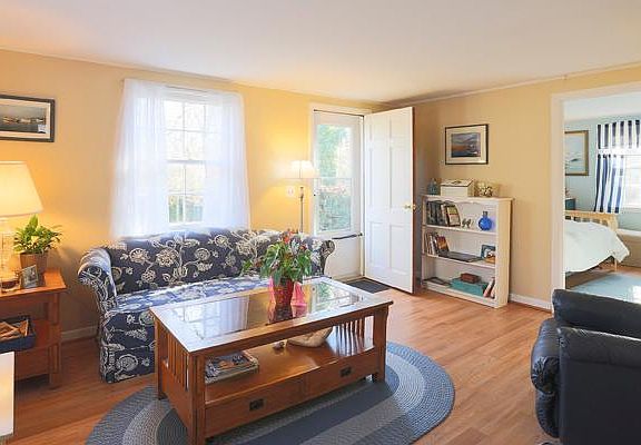 Living room. Furniture now updated. Two couches with wicker coffee table