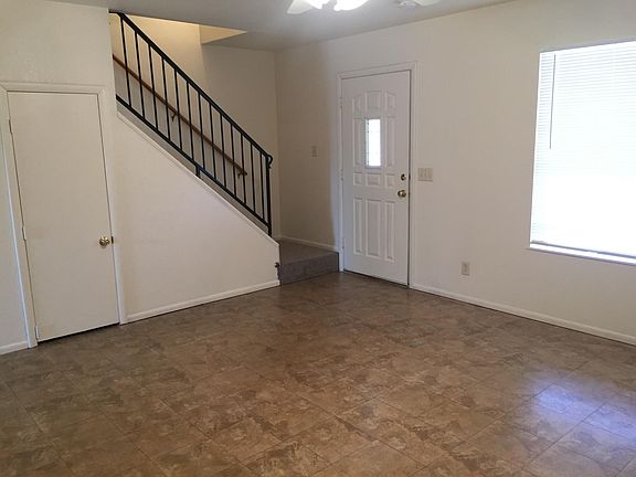 living room with closet storage under stairs
