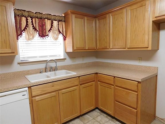LARGE WINDOW OVER THE SINK GIVES YOU A VIEW OF THE OUTDOORS.