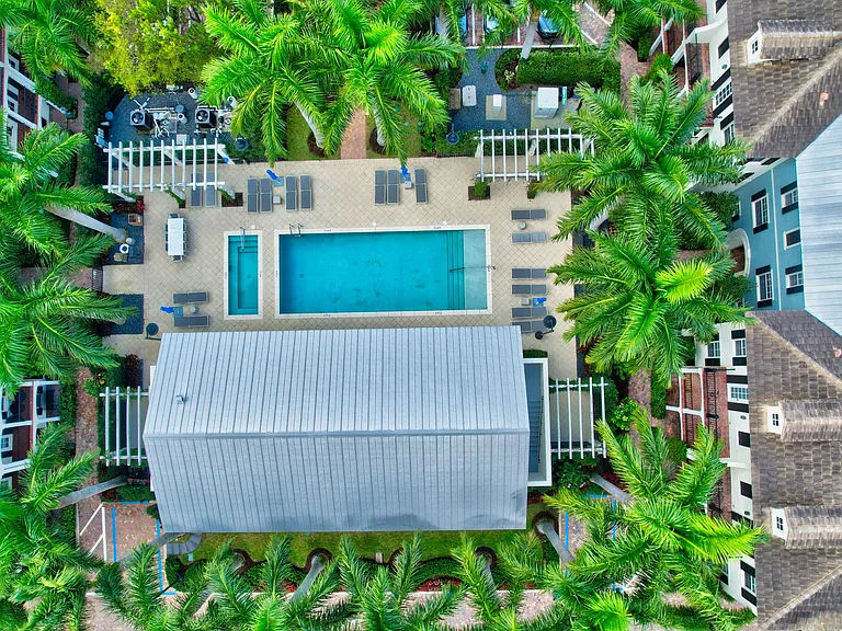 Aerial view of pool, community center and home, which is located bottom right of picture.
