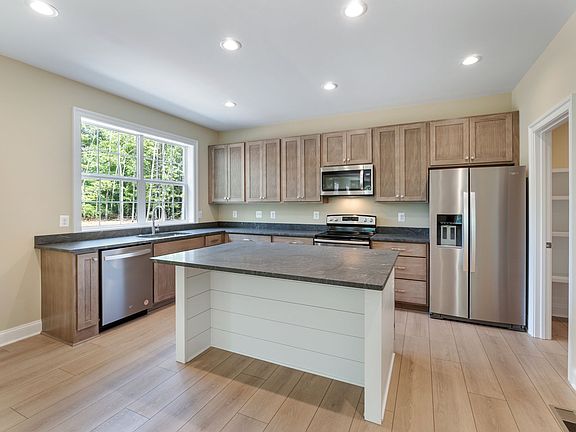Open kitchen with lots of natural light and granite counters