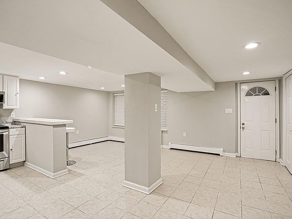 View of living room, kitchen and front door