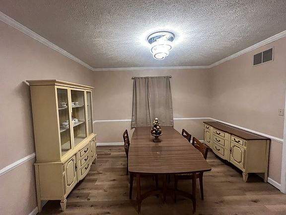 This shows the furnished dining room complete with two buffets all in excellent condition. New modern lighting and new LVP flooring, freshly painted