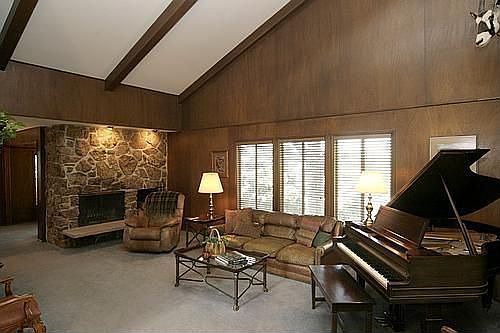 The living room greets guests with vaulted ceilings & a stone fireplace.