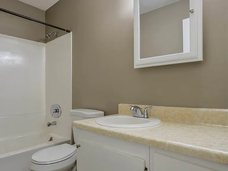 White bathroom vanity with mirror.