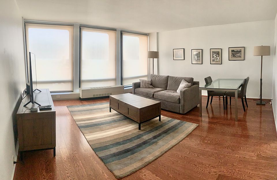 Spacious living room with floor to ceiling windows.