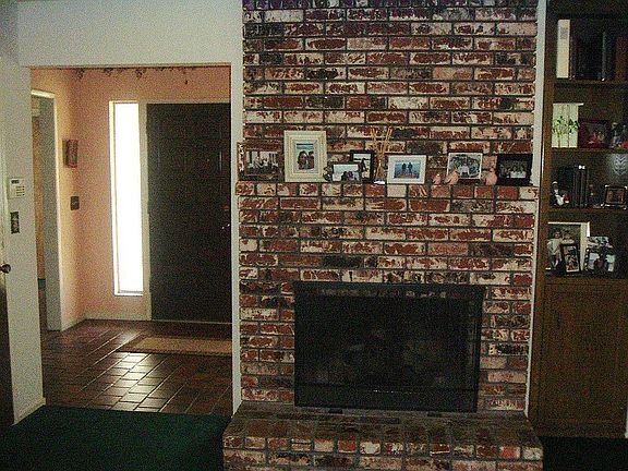 brick fireplace, looking from living room into front foyer. Gas hook-up. 