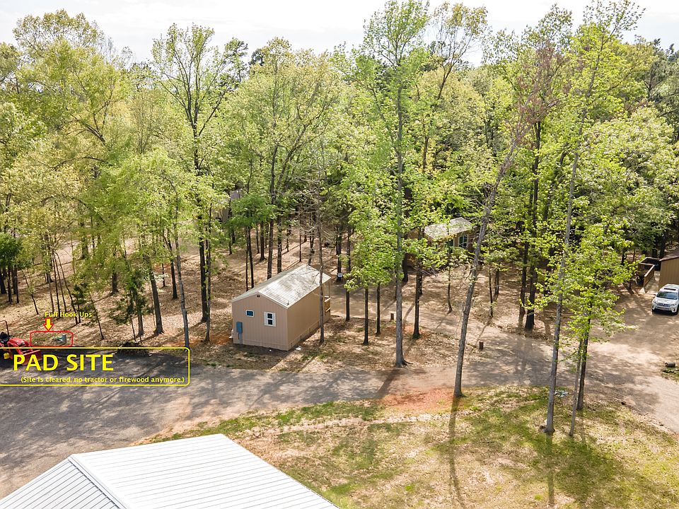 Aerial showing exact site of pad. (Tractor and wood are no longer there. Plenty of room for ATVs, side by side, second car; we also have other room for for boat storage.)