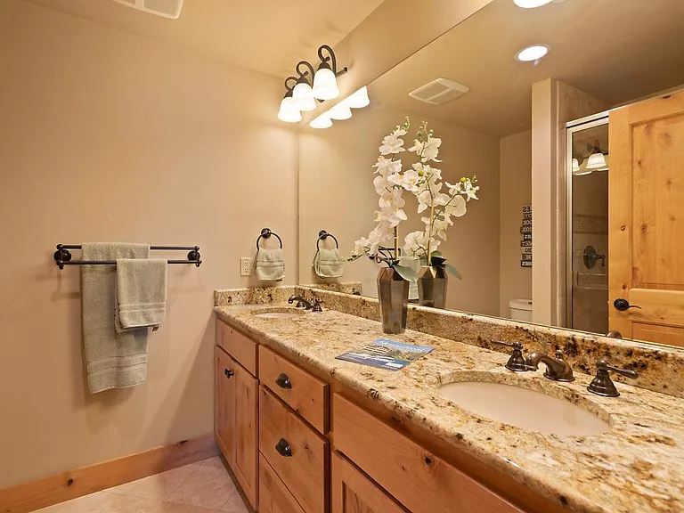 BA #2, his and her sinks, glass shower enclosure, travertine flooring