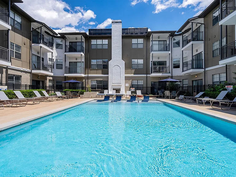 Resort style pool with sundeck and outdoor fireplace