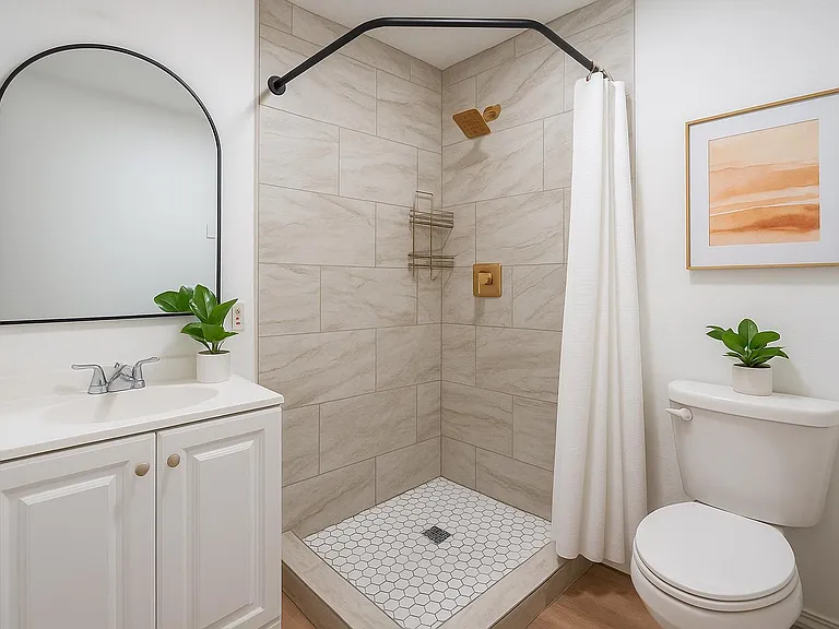 Bright and elegant bath with gold fixtures