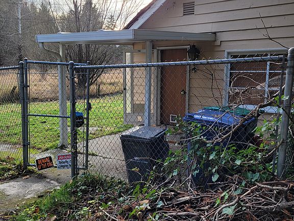 Entrance to home. Awning over entrance. Pasture in background. Total privacy, cannot see any neighbors as they are all way down the road. Love this place.