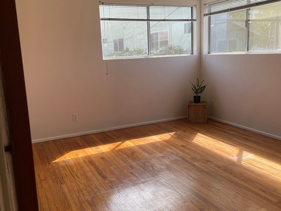 Big bedroom is bright with hardwood floors