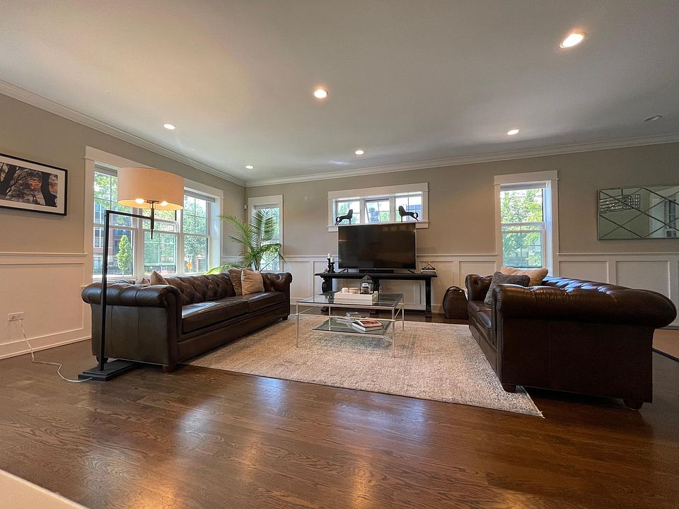 Large living room with leather sofa and loveseat