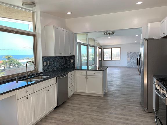 The Gourmet Kitchen with its blue Brazilian granite and ocean glass back splash and top of the line stainless steel appliances