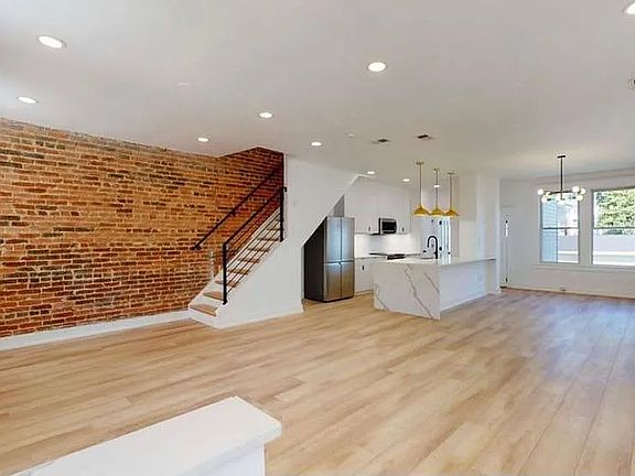 Open concept main level now with a furnished dining room.