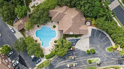 Arial view of pool, clubhouse and gated community entrance