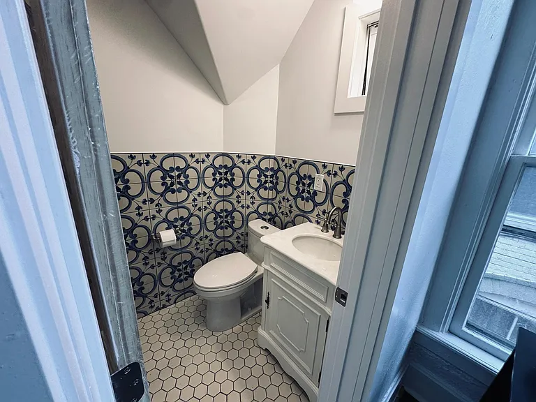 Bathroom entry from the living room view. 
Newly renovated bathroom, walk in shower with rain shower head, handheld shower head, glass sliding door. Water saving toilet, beautiful marble vanity, spanish wall tile.