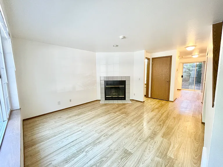 Living Room (note: fireplace to be removed). Coat Closet and access to half bath.