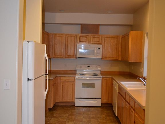 Kitchen of Unit A (remodel in progress for Unit B-kitchen cabinets to change color/new appliances/laminate flooring/new paint)