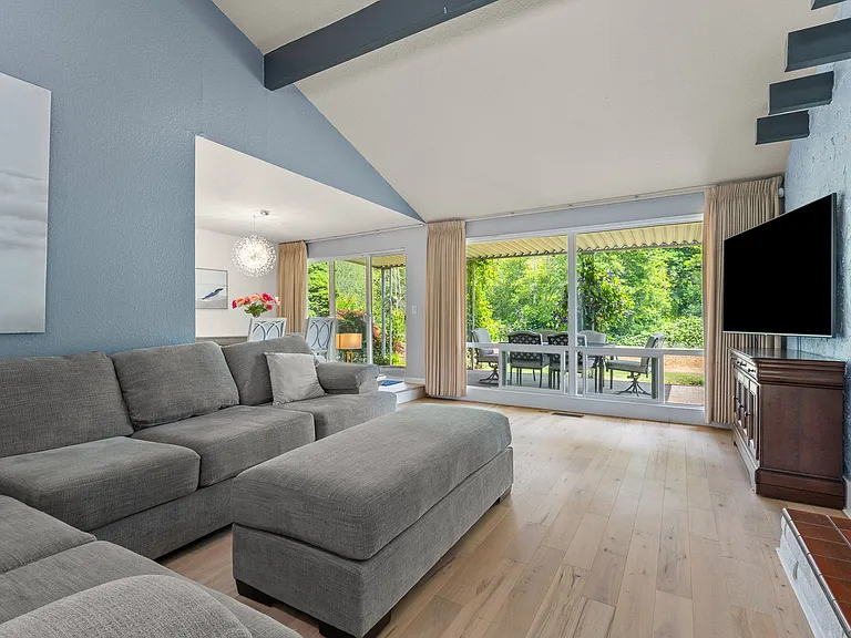 Living room with view out to covered outdoor living space