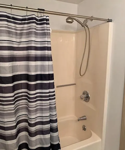Bathroom tub and shower. Handy shower nozzle.