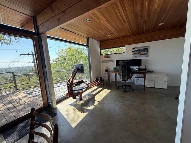 Another view of the second bedroom space that can seamlessly transition from a welcoming guest bedroom to a focused workspace, a relaxed den, or your private fitness area.