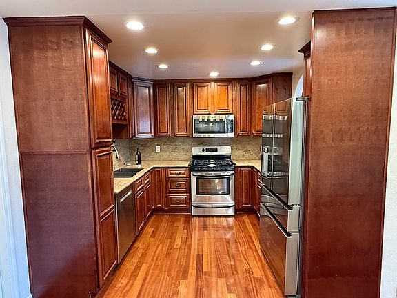 Gourmet kitchen with granite counter top and all stainless steel appliances.