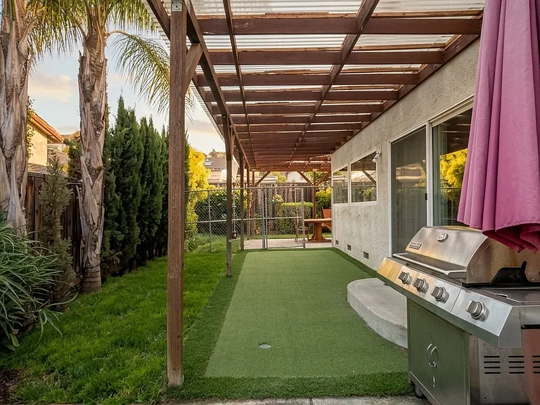 Putty green golf on side yard, with clear cover.