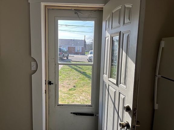 Entry door into Kitchen looking into back yard and parking.