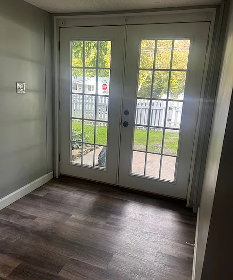 French doors leading out of basement to front yard